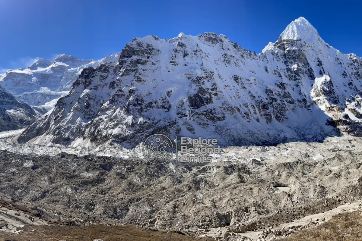 Kanchenjunga's summit ridge seen from the approach trail near Pangpema, snow peaks against a clear sky