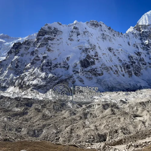 Kanchenjunga's summit ridge seen from the approach trail near Pangpema, snow peaks against a clear sky
