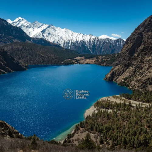 The turquoise water of Phoksundo Lake framed by cliffs, Shey Phoksundo National Park, Dolpo